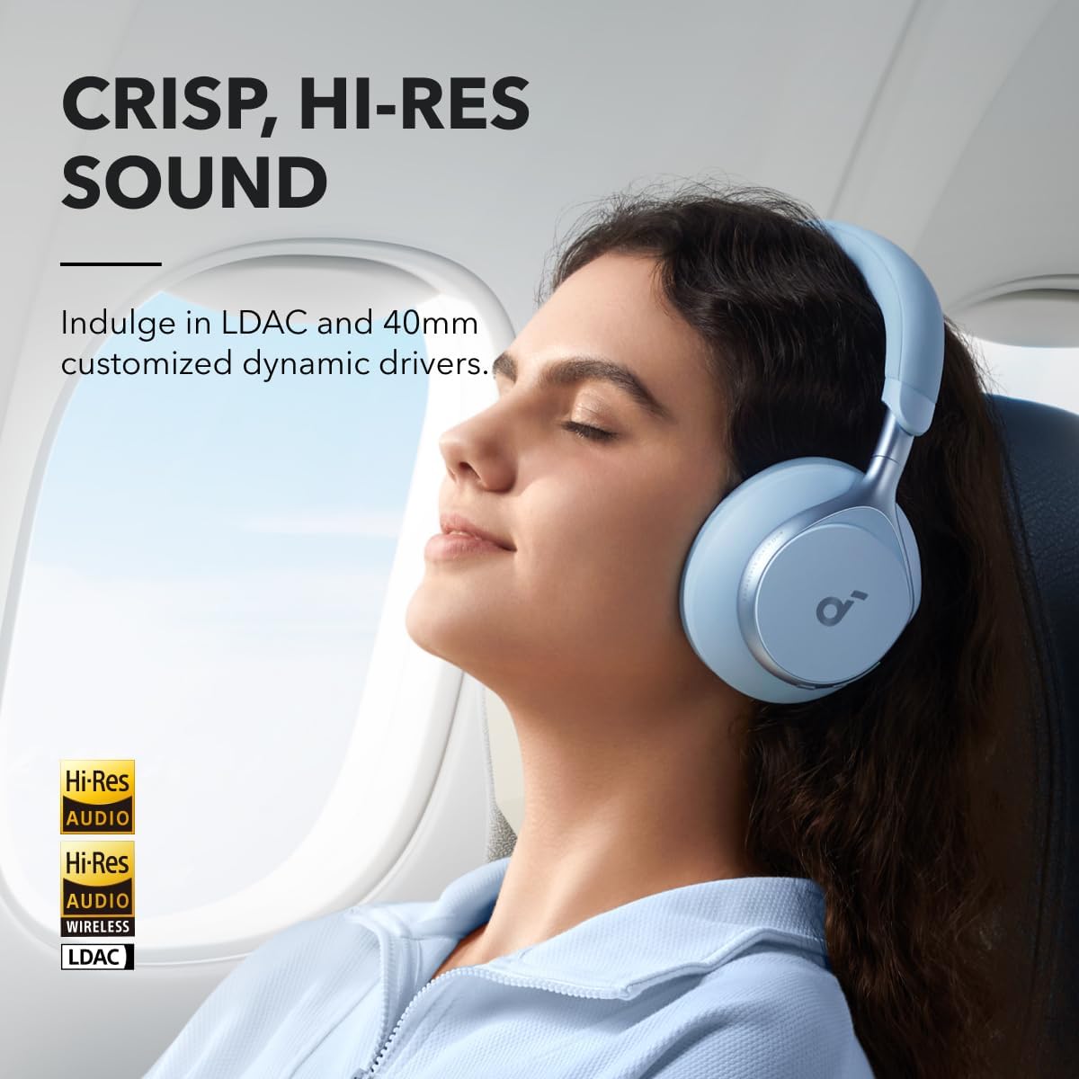 Woman sleeping on a plane wearing a pair of Soundcore Space One headphones